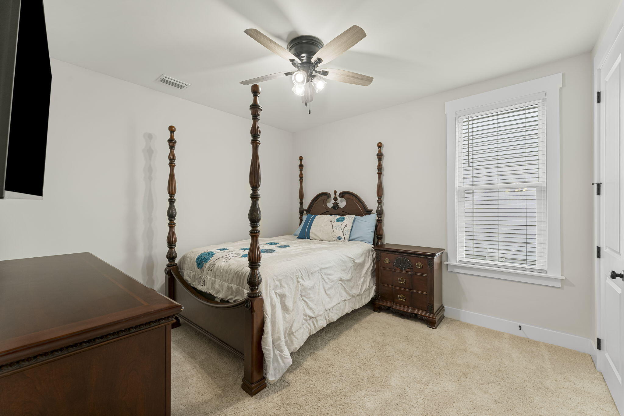 1921 Rushes Avenue Panama City, FL 32405 - Photo 10 of 43 a bedroom with a bed and a chandelier