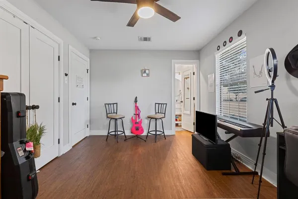 a living room with furniture a wooden floor and a flat screen tv