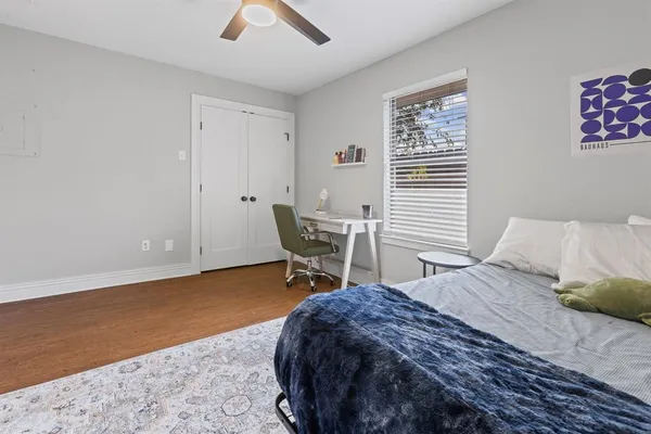 a bedroom with a bed and a window