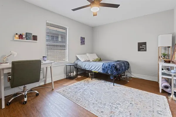 a living room with a bed furniture and a window