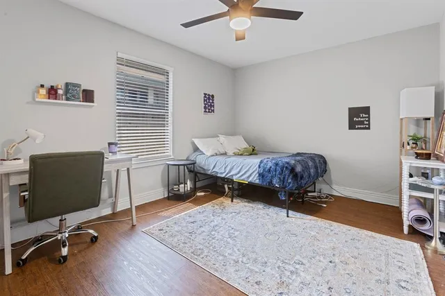 a living room with a bed furniture and a window