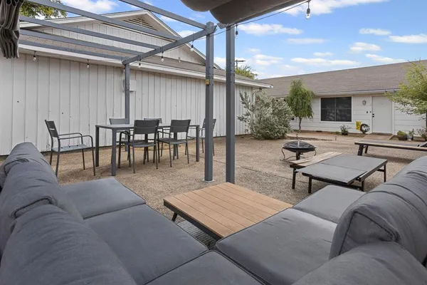 a view of a backyard with furniture and a garden
