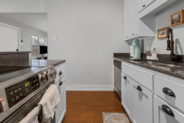 a kitchen with stainless steel appliances granite countertop a stove and a sink