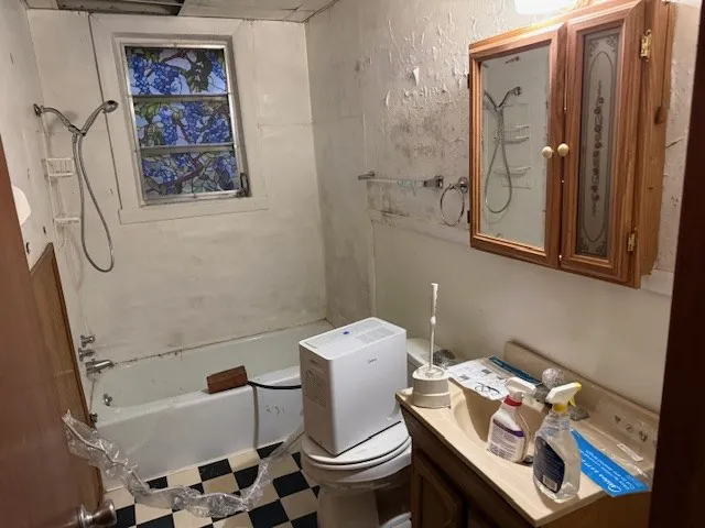 a bathroom with a toilet and a shower curtain