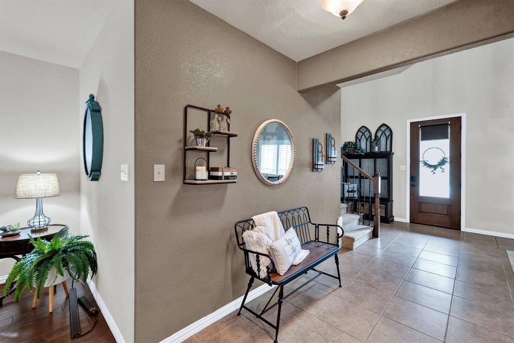 1701 Meadow Ranch Road McKinney, TX 75071 - Photo 3 of 40 a view of a livingroom with furniture and a wooden floor