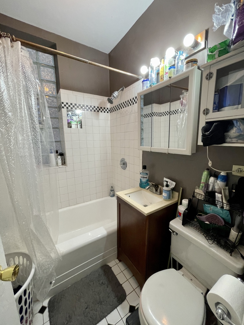 1907 West Cortland Street, Unit 2 Chicago, IL 60622 - Photo 11 of 11 a bathroom with a sink toilet vanity and tub