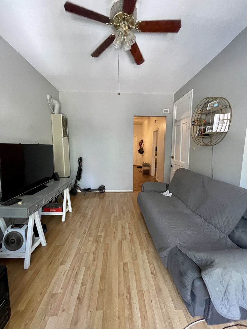 1907 West Cortland Street, Unit 2 Chicago, IL 60622 - Photo 2 of 11 a living room with furniture and a flat screen tv