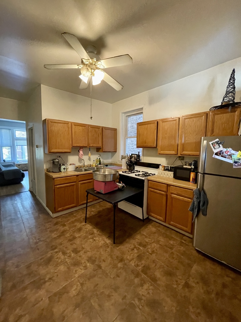 1907 West Cortland Street, Unit 2 Chicago, IL 60622 - Photo 7 of 11 a kitchen with a refrigerator cabinets and wooden floor