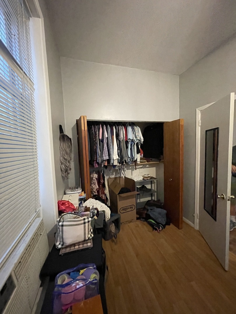 1907 West Cortland Street, Unit 2 Chicago, IL 60622 - Photo 9 of 11 a living room with furniture a flat screen tv and a window