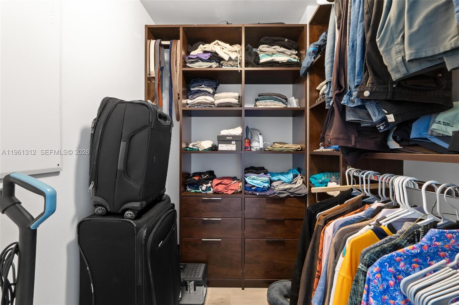 45 Southwest 9th Street, Unit 1109 Miami, FL 33130 - Photo 14 of 25 a view of walk in closet with clothes and shoes