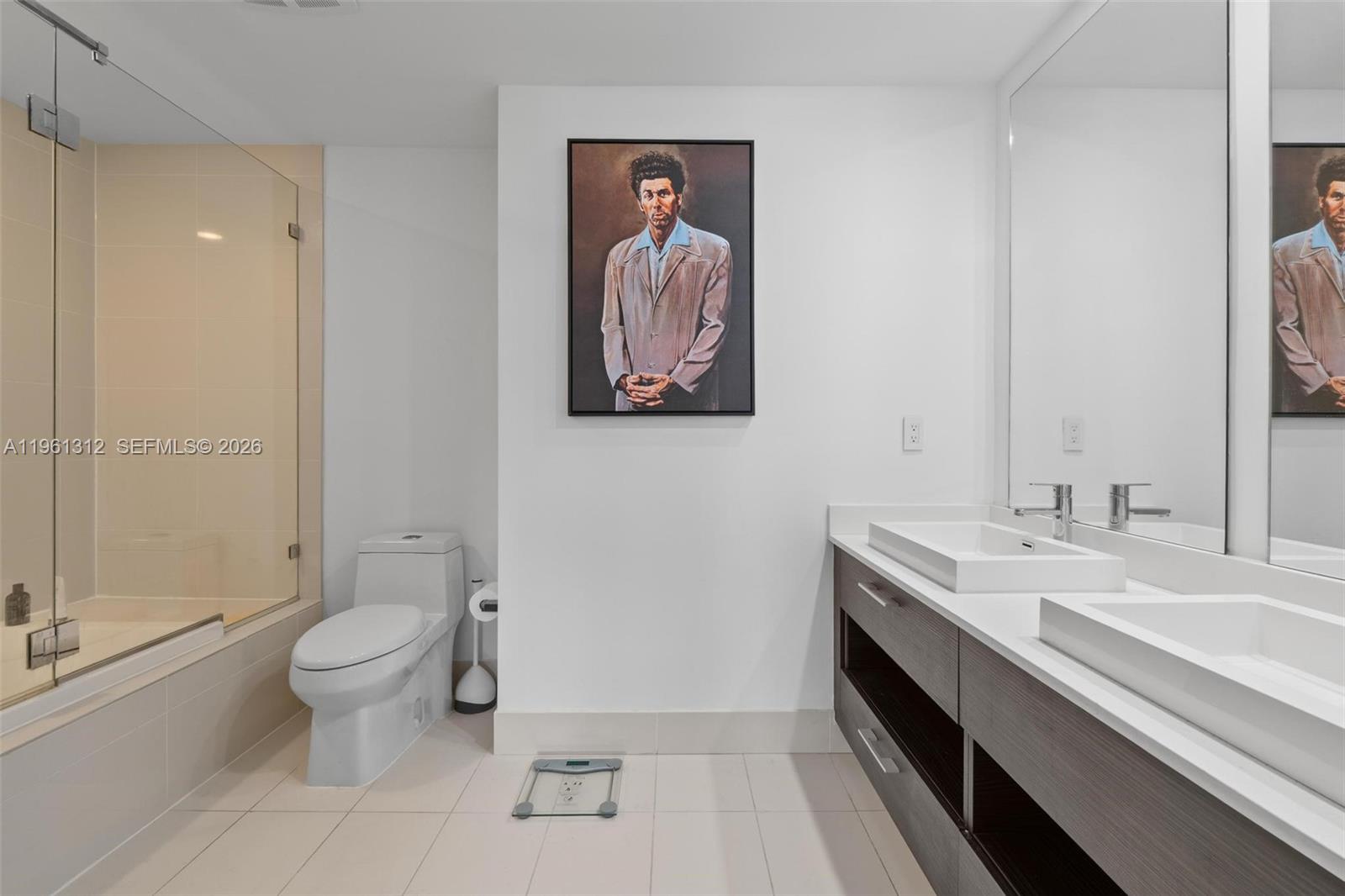 45 Southwest 9th Street, Unit 1109 Miami, FL 33130 - Photo 15 of 25 a spacious bathroom with a sink and a mirror