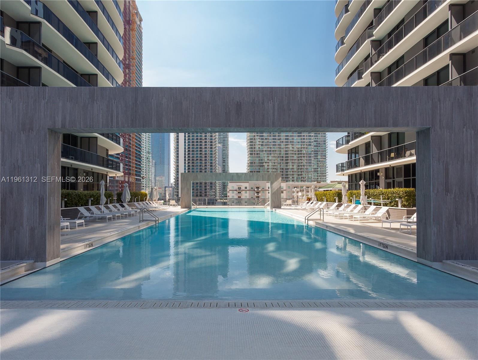 45 Southwest 9th Street, Unit 1109 Miami, FL 33130 - Photo 19 of 25 a view of a swimming pool with outdoor seating