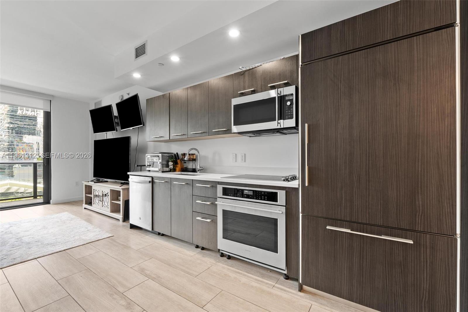 45 Southwest 9th Street, Unit 1109 Miami, FL 33130 - Photo 3 of 25 a kitchen with stainless steel appliances granite countertop a refrigerator oven a sink and dishwasher