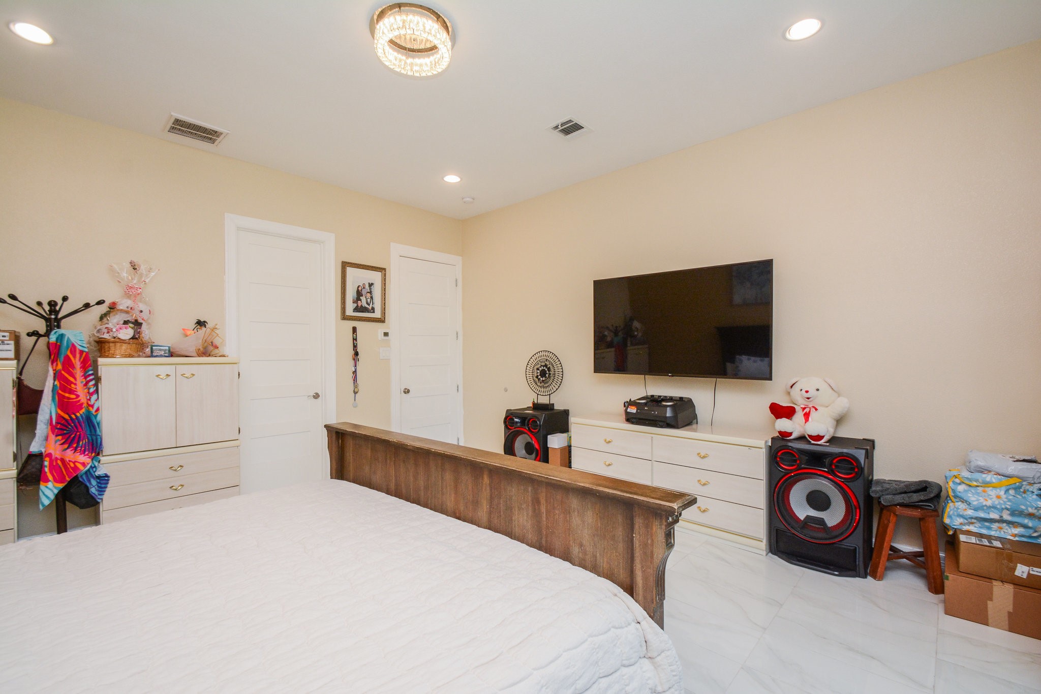 5513 Lotus Street Houston, TX 77085 - Photo 17 of 50 a bedroom with furniture and a flat screen tv