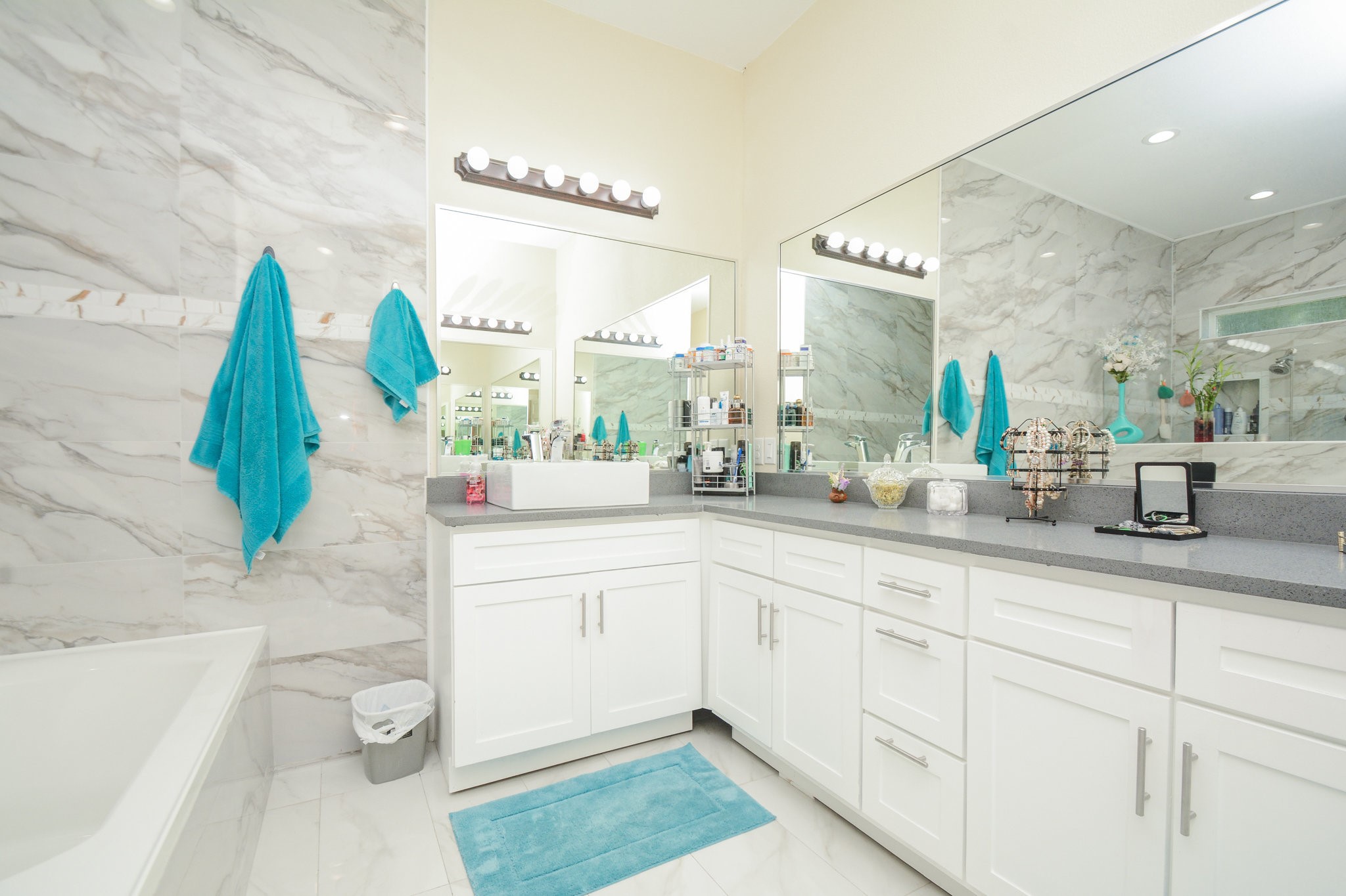 5513 Lotus Street Houston, TX 77085 - Photo 19 of 50 a bathroom with a sink a mirror and a bathtub