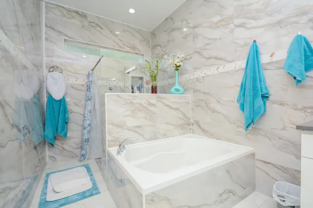 a bath tub sitting in a bathroom next to a white tub