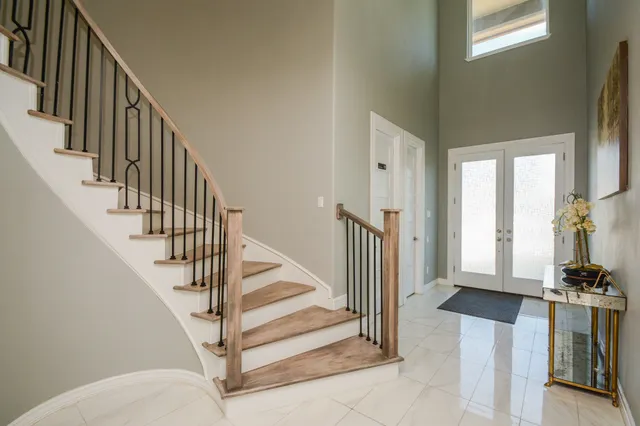 a view of entryway and hall with wooden floor