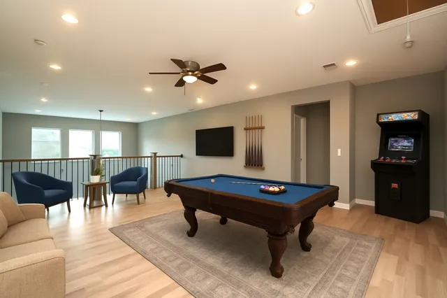 a living room with furniture a table and flat screen tv