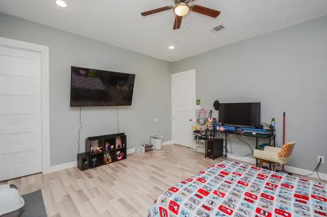 a bedroom with a bed and a flat screen tv