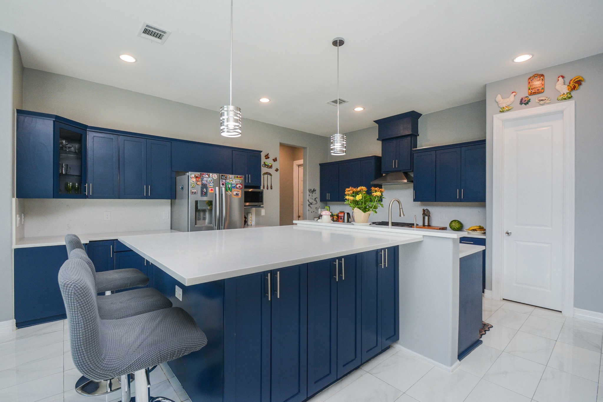 5513 Lotus Street Houston, TX 77085 - Photo 7 of 50 a kitchen with a refrigerator a sink and chairs