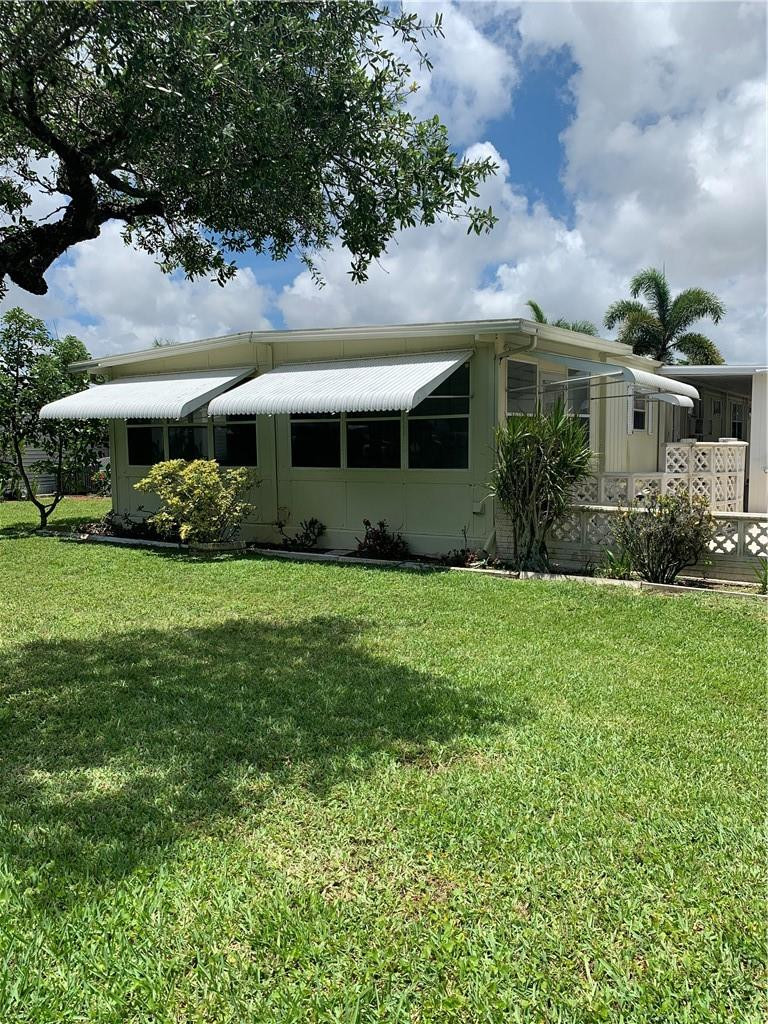 8257 East Club Road Boca Raton, FL 33433 - Photo 11 of 28 a front view of house with yard and green space