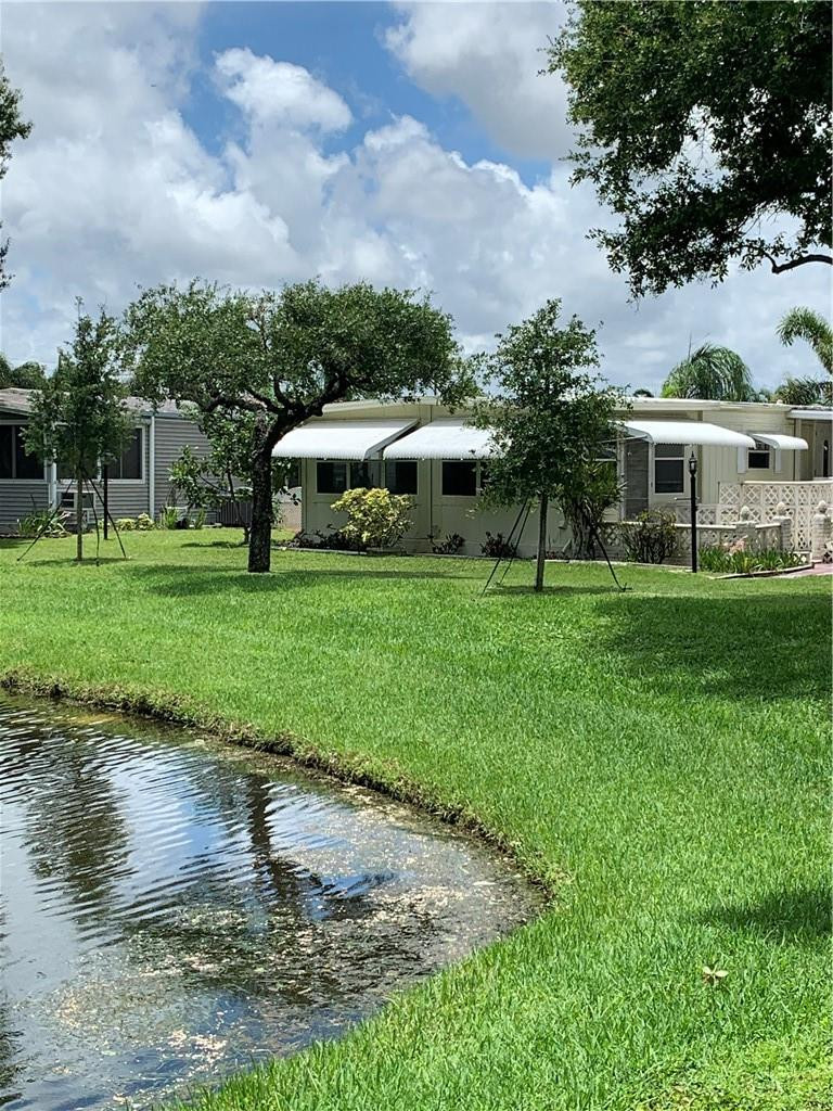 8257 East Club Road Boca Raton, FL 33433 - Photo 19 of 28 a front view of house with yard and green space