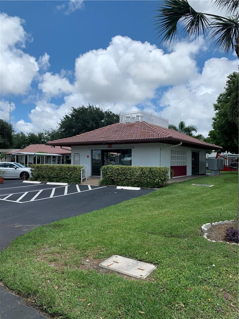 8257 East Club Road Boca Raton, FL 33433 - Photo 20 of 28 a view of a house with a back yard