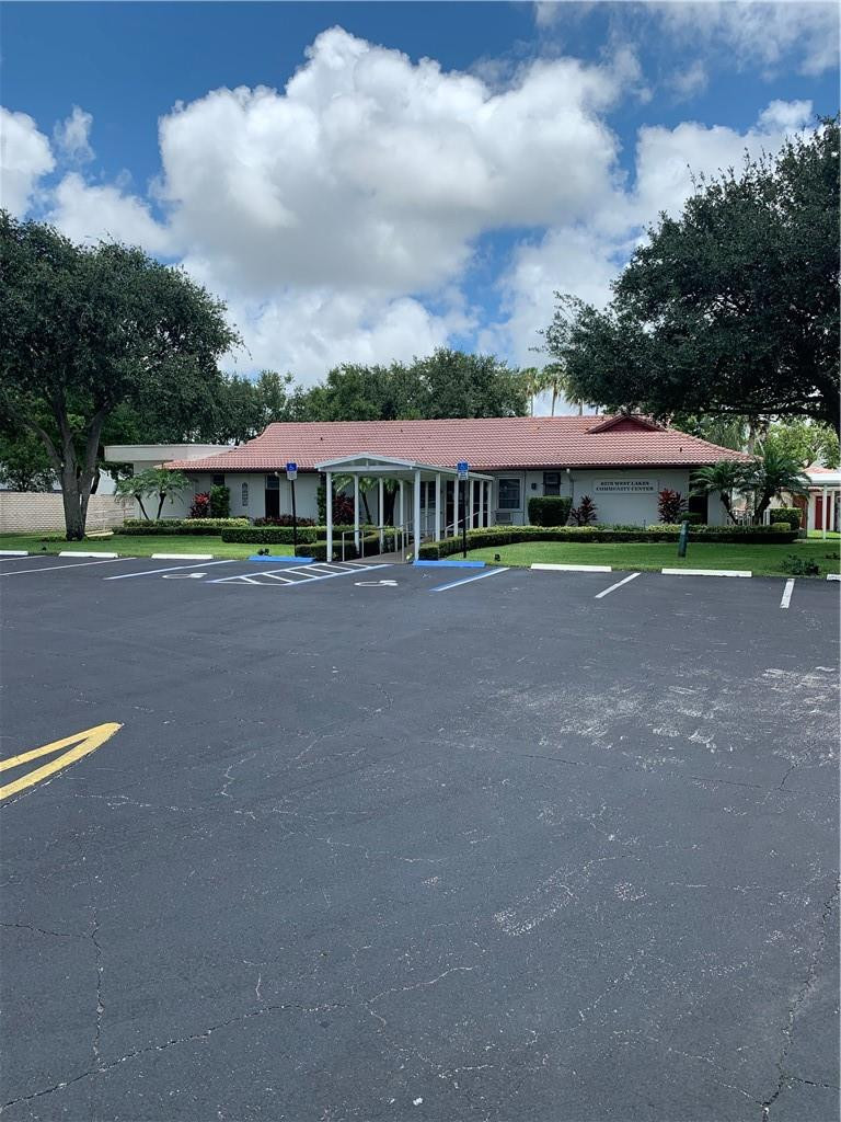 8257 East Club Road Boca Raton, FL 33433 - Photo 21 of 28 a view of swimming pool in front of residential house with outdoor seating