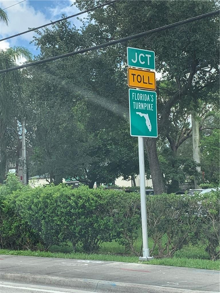 8257 East Club Road Boca Raton, FL 33433 - Photo 28 of 28 a sign that is on the side of a road