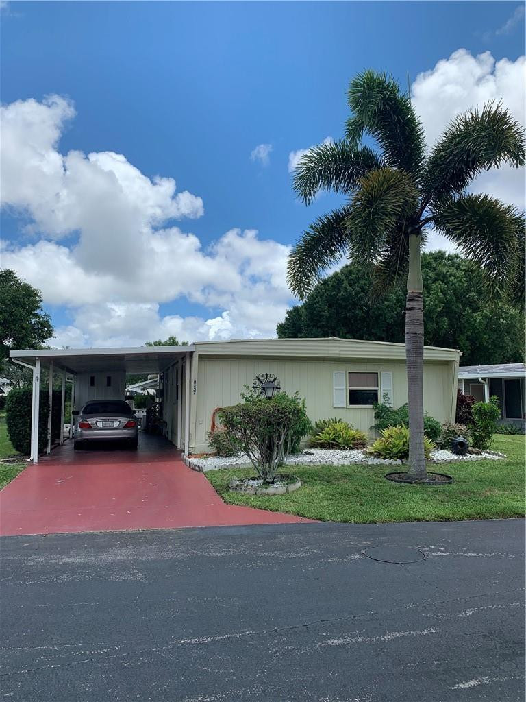 8257 East Club Road Boca Raton, FL 33433 - Photo 4 of 28 a view of a house with a yard and potted plants