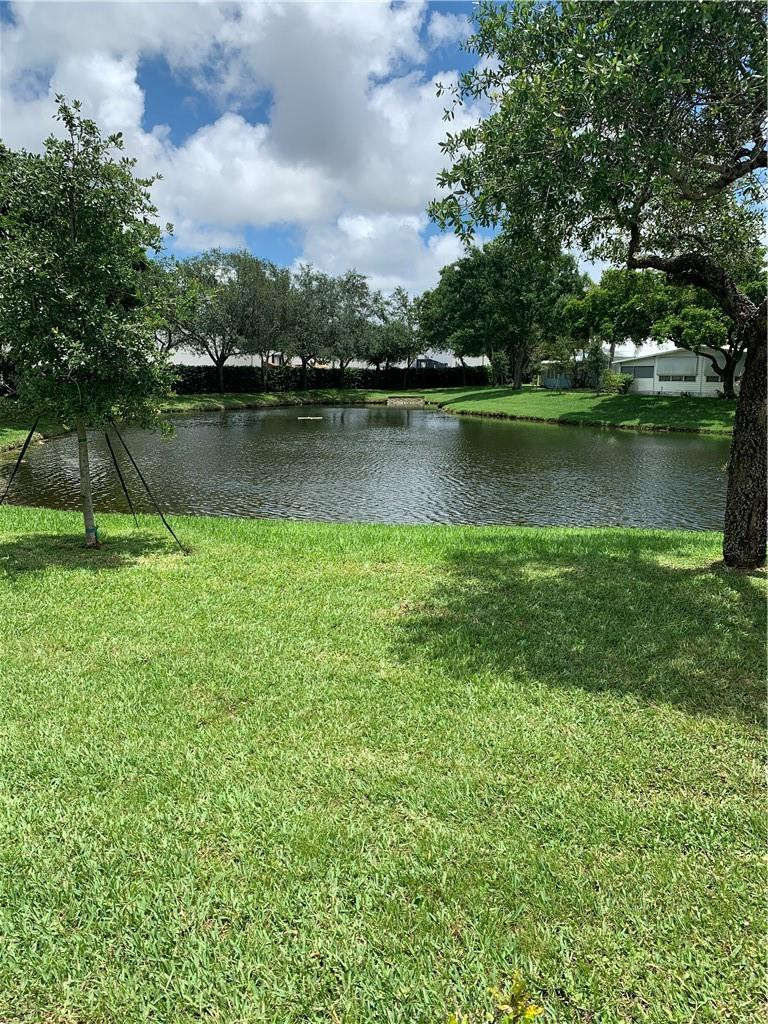 8257 East Club Road Boca Raton, FL 33433 - Photo 6 of 28 a view of a lake with houses in the back