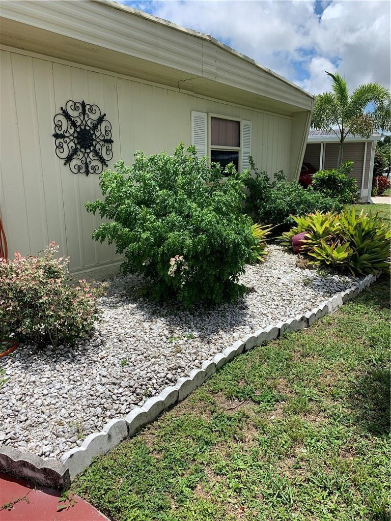 8257 East Club Road Boca Raton, FL 33433 - Photo 7 of 28 a front view of a house with a yard