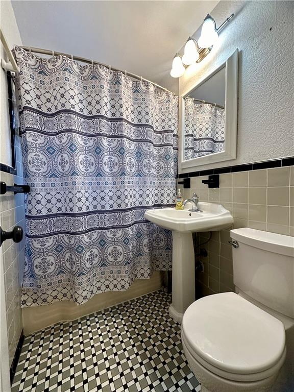 6665 Colonial Road, Unit 2F Brooklyn, NY 11220 - Photo 18 of 25 a bathroom with a sink toilet and mirror