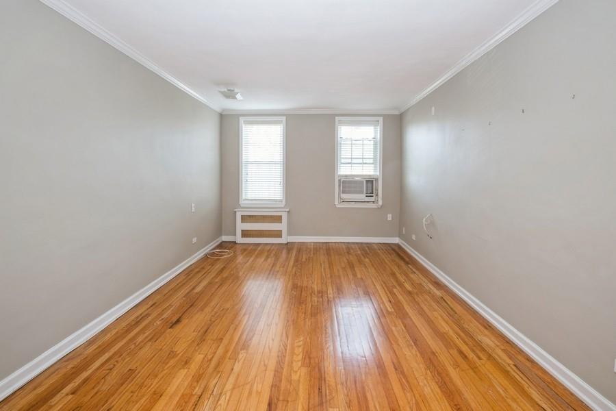 6665 Colonial Road, Unit 2F Brooklyn, NY 11220 - Photo 5 of 25 an empty room with wooden floor and windows