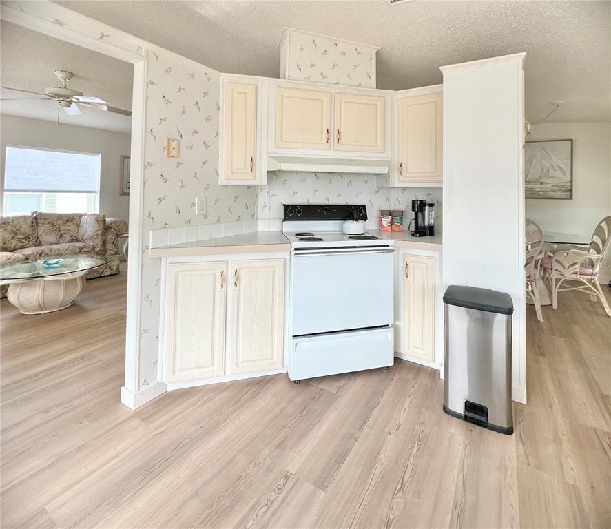 1100 South Belcher Road, Unit 391 Largo, FL 33771 - Photo 11 of 60 a kitchen with a white cabinets and white appliances
