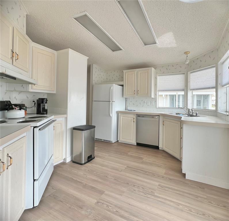 1100 South Belcher Road, Unit 391 Largo, FL 33771 - Photo 12 of 60 a kitchen with a sink cabinets stainless steel appliances and a window