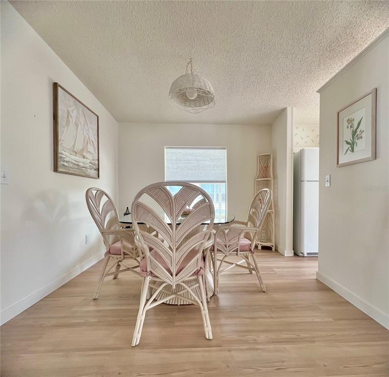 1100 South Belcher Road, Unit 391 Largo, FL 33771 - Photo 15 of 60 a dining room with furniture and wooden floor