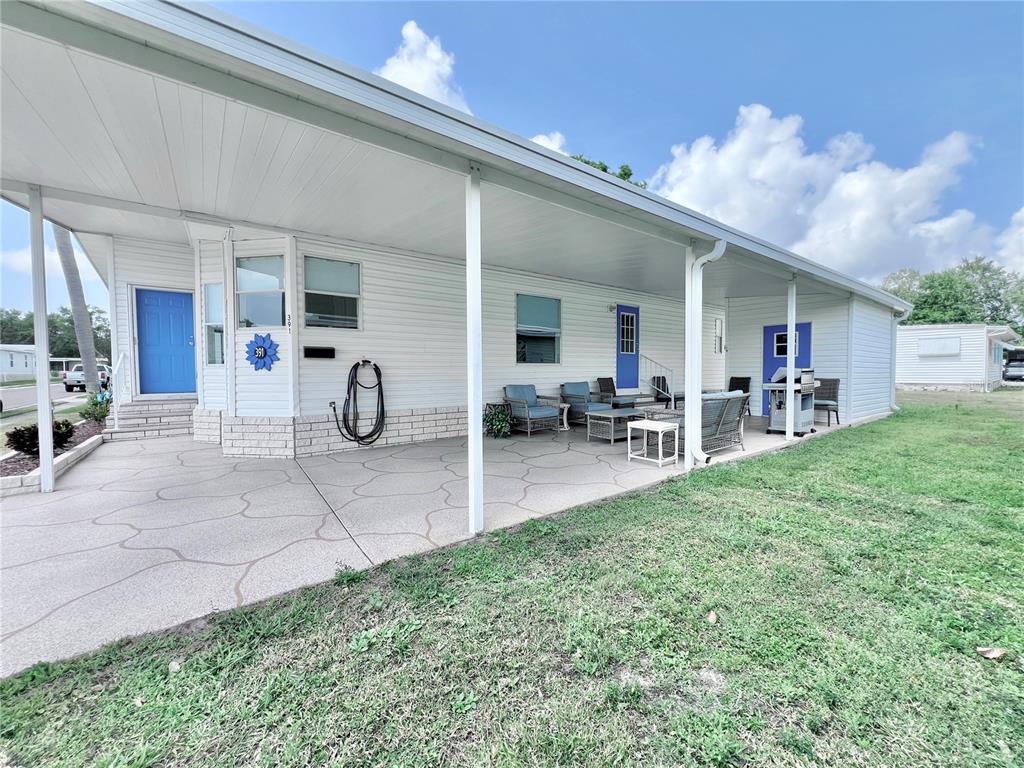 1100 South Belcher Road, Unit 391 Largo, FL 33771 - Photo 6 of 60 a view of a porch with chairs and backyard