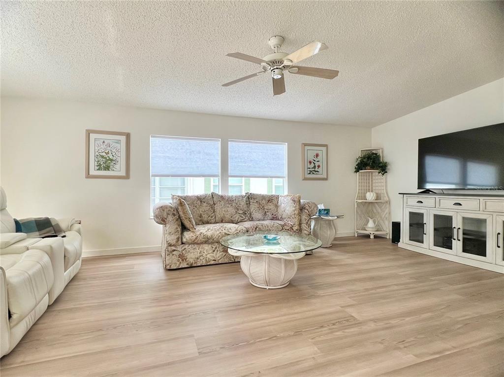 1100 South Belcher Road, Unit 391 Largo, FL 33771 - Photo 8 of 60 a living room with furniture and a flat screen tv