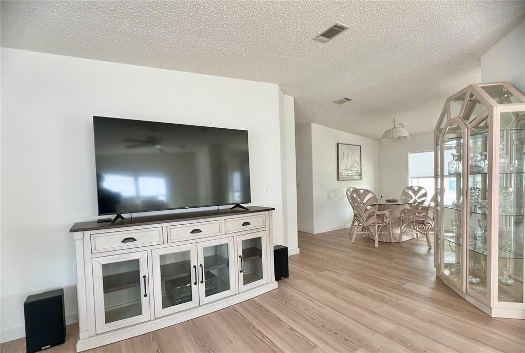 1100 South Belcher Road, Unit 391 Largo, FL 33771 - Photo 10 of 60 a living room with furniture and a flat screen tv