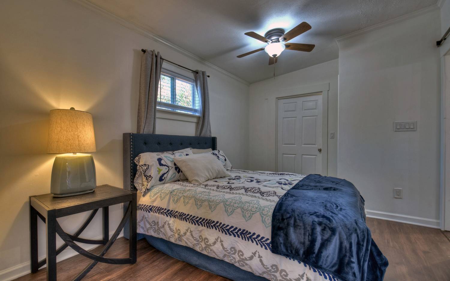 642 East 2nd Street Blue Ridge, GA 30513 - Photo 31 of 44 a bedroom with a bed and a chandelier