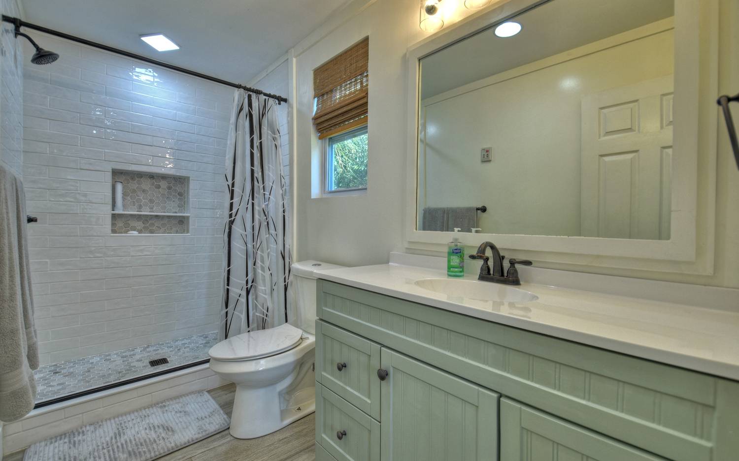 642 East 2nd Street Blue Ridge, GA 30513 - Photo 38 of 44 a bathroom with a granite countertop sink a toilet and a mirror