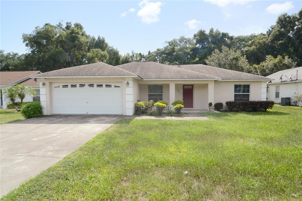 1476 Old Apopka Road Apopka, FL 32703 - Photo 1 of 1 a front view of a house with a garden and plants