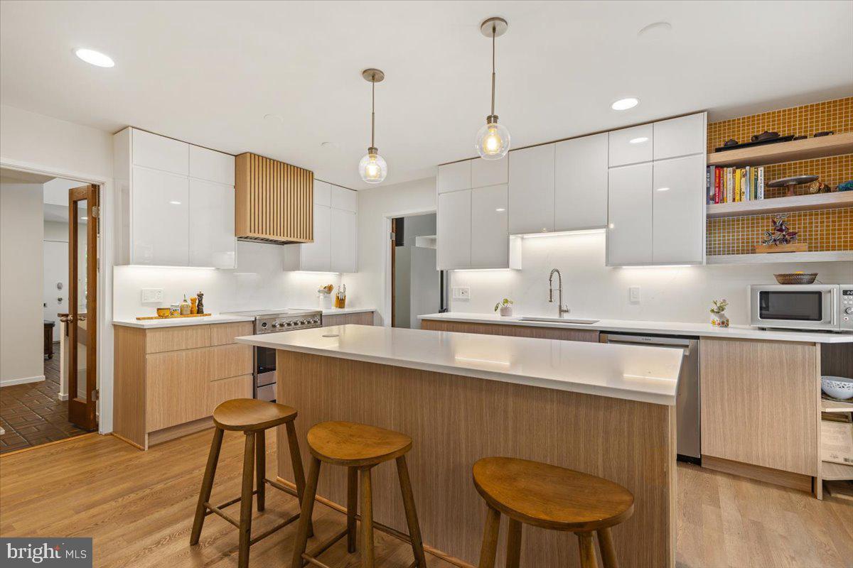 9411 Fernwood Road Bethesda, MD 20817 - Photo 2 of 28 a kitchen with stainless steel appliances a sink a stove a refrigerator and chairs
