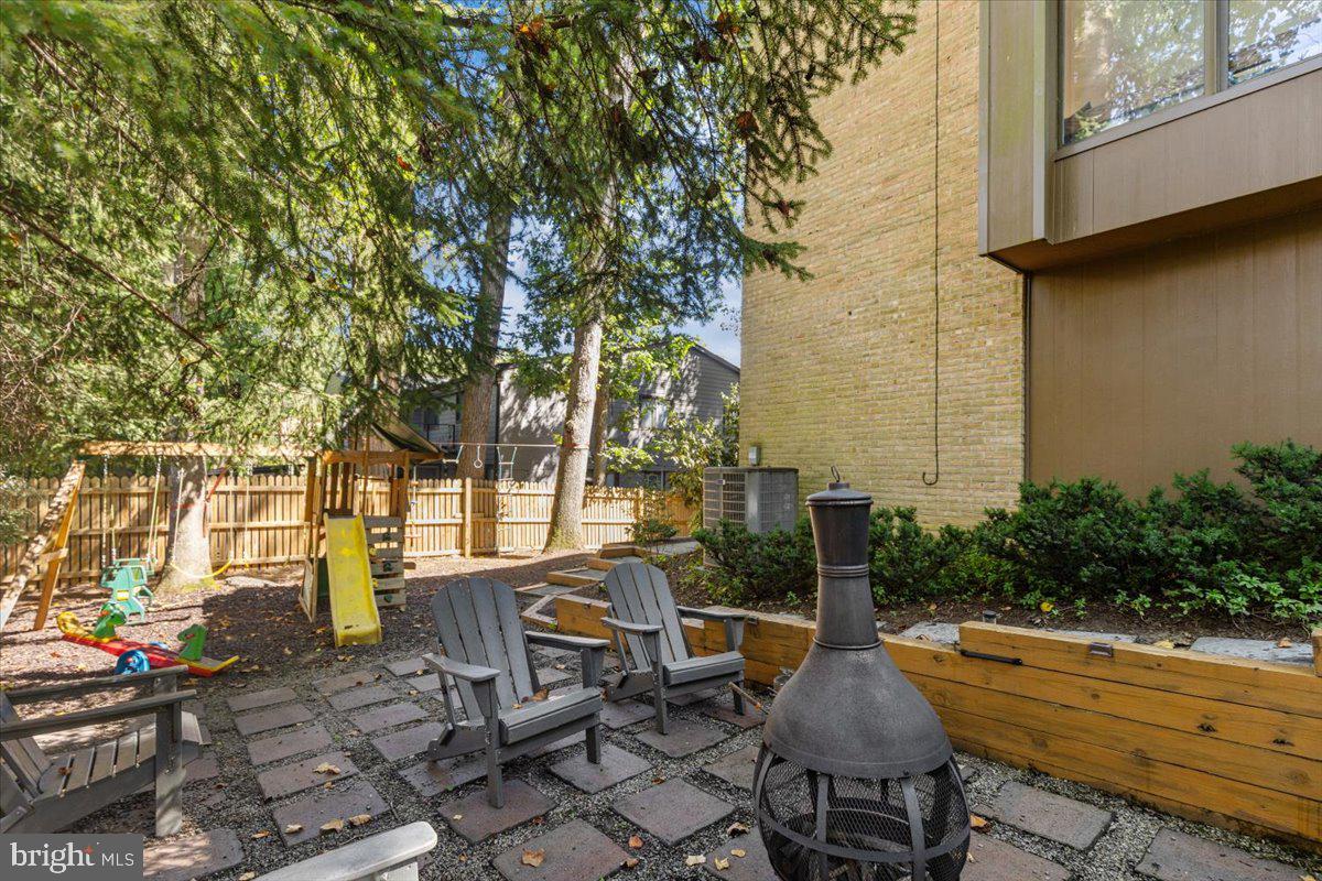 9411 Fernwood Road Bethesda, MD 20817 - Photo 22 of 28 a view of a patio with couches table and chairs and potted plants
