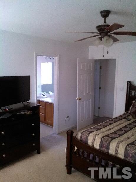 917 Clayton Road Durham, NC 27703 - Photo 14 of 24 a bedroom with a bed and a flat screen tv
