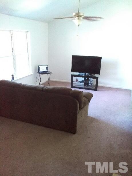 917 Clayton Road Durham, NC 27703 - Photo 22 of 24 a living room with furniture and a flat screen tv