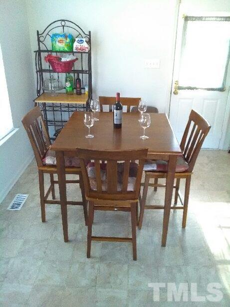 917 Clayton Road Durham, NC 27703 - Photo 8 of 24 a view of a dining room with furniture and a window