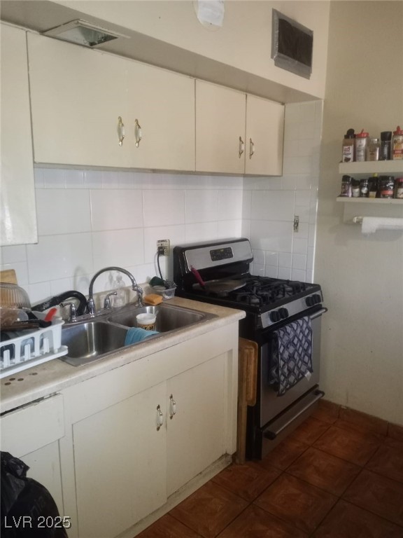 2120 Glider Street North Las Vegas, NV 89030 - Photo 50 of 50 Kitchen featuring light countertops, a sink, stain