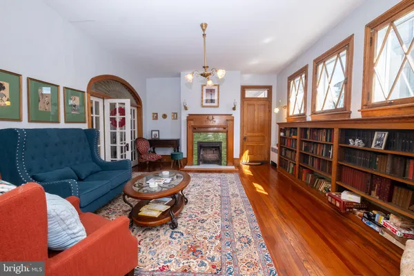 a living room with fireplace furniture and a chandelier
